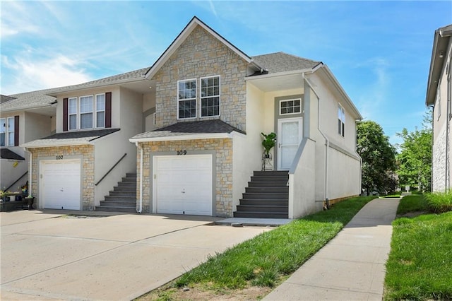 1201 N Mart-Way Dr Unit 109, Olathe, KS 66061 - multi unit property with stone siding, stucco siding, an attached garage, and driveway