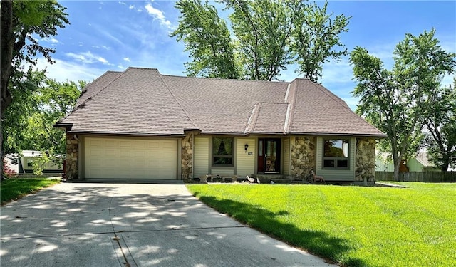 10951 Nieman Rd, Overland Park, KS 66210 - view of front facade with stone siding, a garage, and concrete driveway