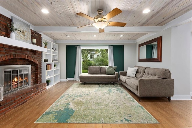 10234 Monrovia St, Lenexa, KS 66215 - living area with baseboards, wood finished floors, recessed lighting, a brick fireplace, and wooden ceiling