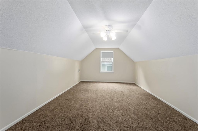 10234 Monrovia St, Lenexa, KS 66215 - bonus room featuring a ceiling fan, carpet floors, lofted ceiling, baseboards, and a textured ceiling