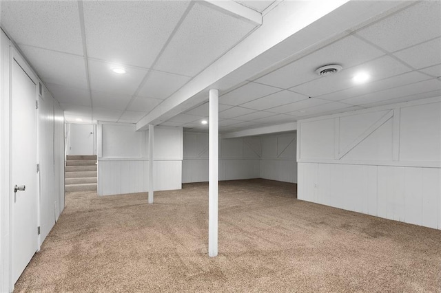 10234 Monrovia St, Lenexa, KS 66215 - finished below grade area with carpet, a decorative wall, recessed lighting, a drop ceiling, and stairway