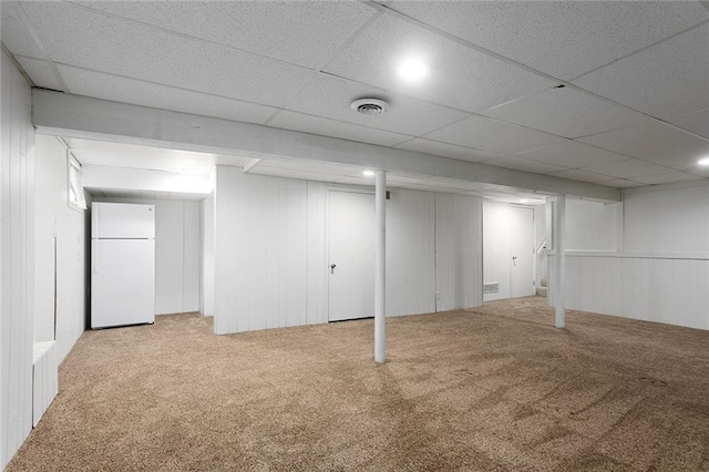 10234 Monrovia St, Lenexa, KS 66215 - finished basement featuring freestanding refrigerator, carpet floors, and a decorative wall