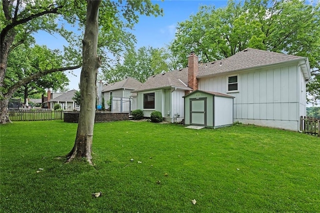 10234 Monrovia St, Lenexa, KS 66215 - back of property featuring a chimney, a shingled roof, and board and batten siding