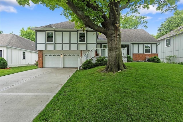 10234 Monrovia St, Lenexa, KS 66215 - view of front of property with brick siding, driveway, a garage, a front lawn, and roof with shingles