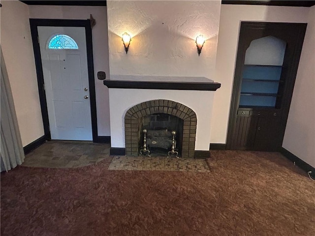 unfurnished living room featuring baseboards, carpet floors, and a fireplace with flush hearth