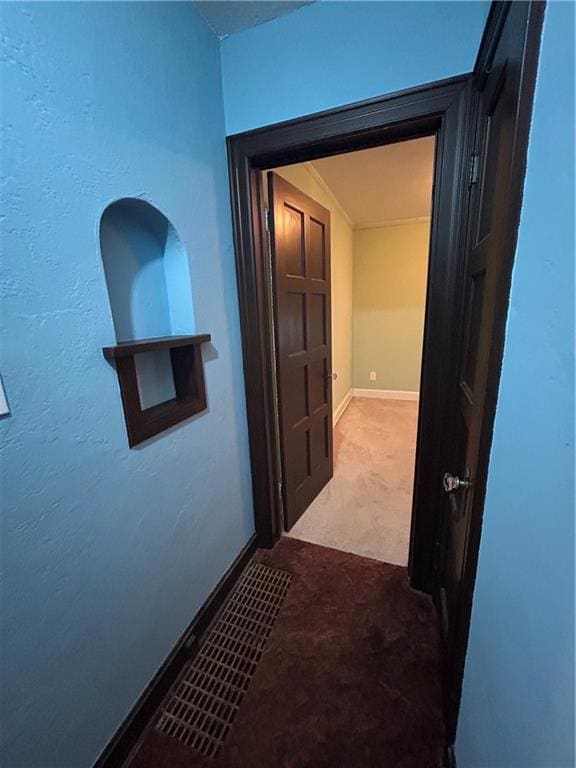 corridor with carpet floors and baseboards