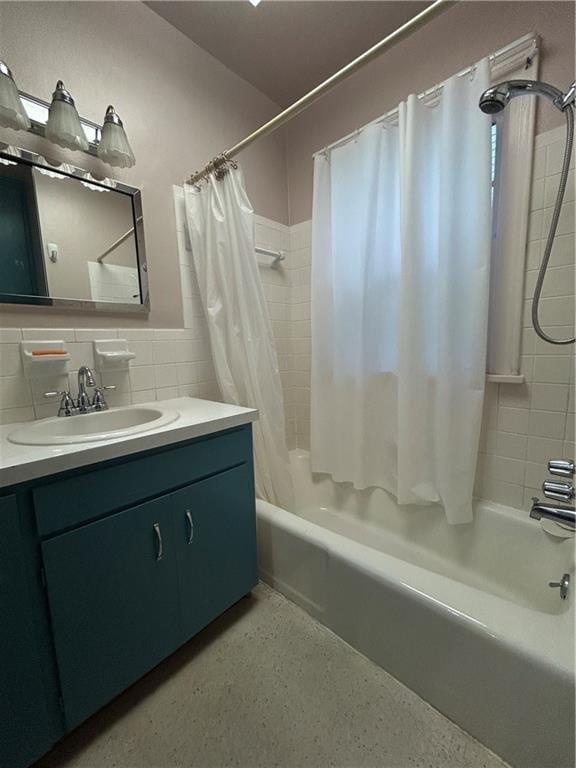 bathroom with shower / bath combination with curtain, vanity, and speckled floor