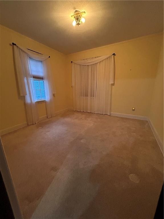 unfurnished bedroom featuring baseboards and carpet flooring