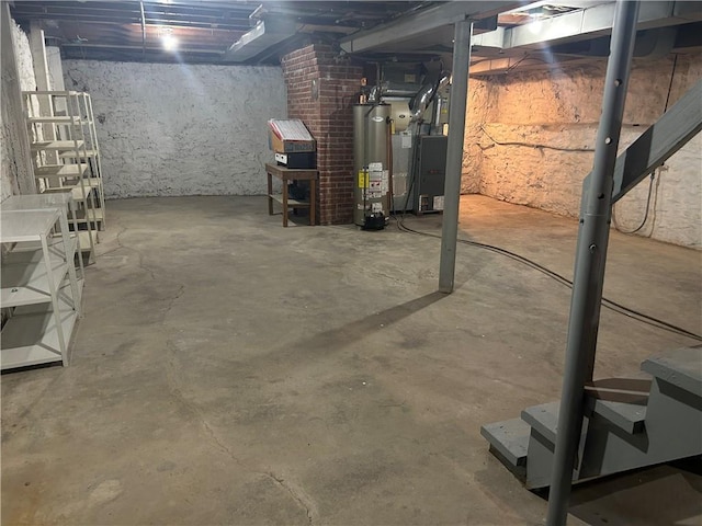 unfinished basement featuring water heater and heating unit