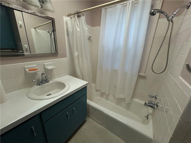 full bath with shower / tub combo with curtain, vanity, backsplash, and tile walls