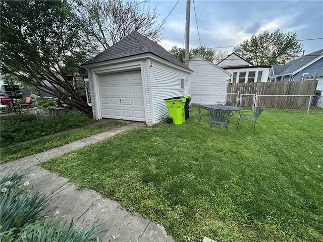 view of yard with an outdoor structure and a detached garage