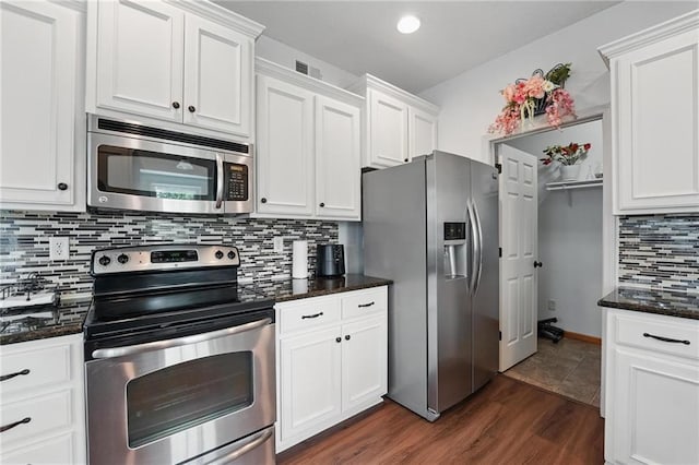 1605 NW Primrose Ln, Blue Springs, MO 64015 - kitchen featuring stainless steel appliances, backsplash, white cabinetry, dark wood-style flooring, and recessed lighting