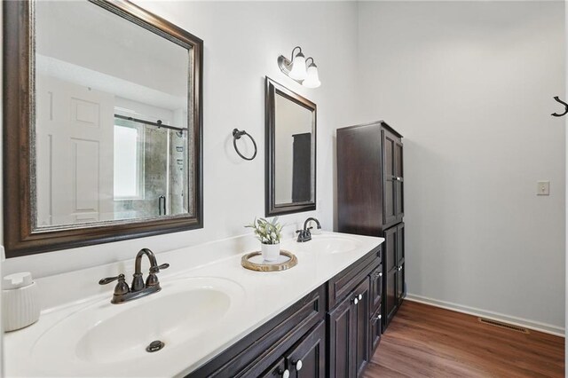 1605 NW Primrose Ln, Blue Springs, MO 64015 - bathroom featuring double vanity and wood finished floors