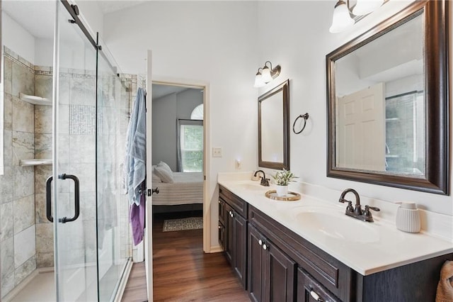 1605 NW Primrose Ln, Blue Springs, MO 64015 - bathroom with double vanity, a stall shower, wood finished floors, and connected bathroom