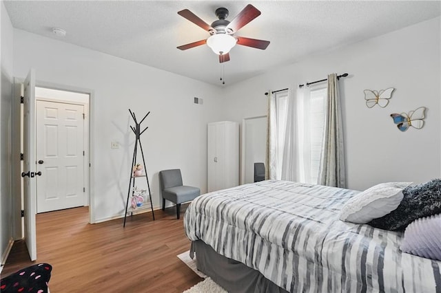 1605 NW Primrose Ln, Blue Springs, MO 64015 - bedroom with wood finished floors and a ceiling fan