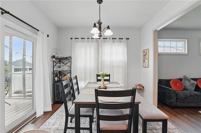 1605 NW Primrose Ln, Blue Springs, MO 64015 - dining area with dark wood finished floors, a chandelier, and a textured ceiling