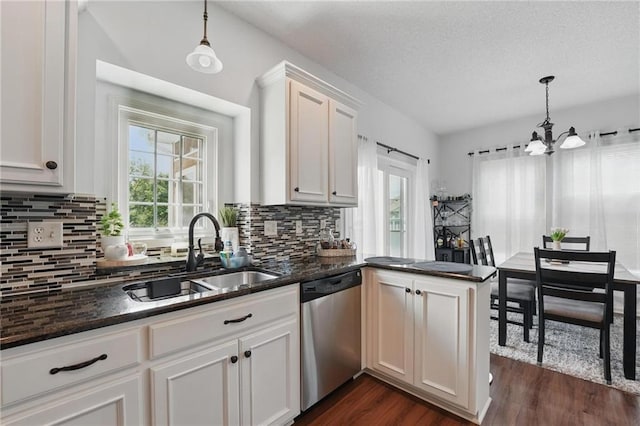 1605 NW Primrose Ln, Blue Springs, MO 64015 - kitchen featuring dishwasher, plenty of natural light, a chandelier, dark wood-style floors, and a textured ceiling