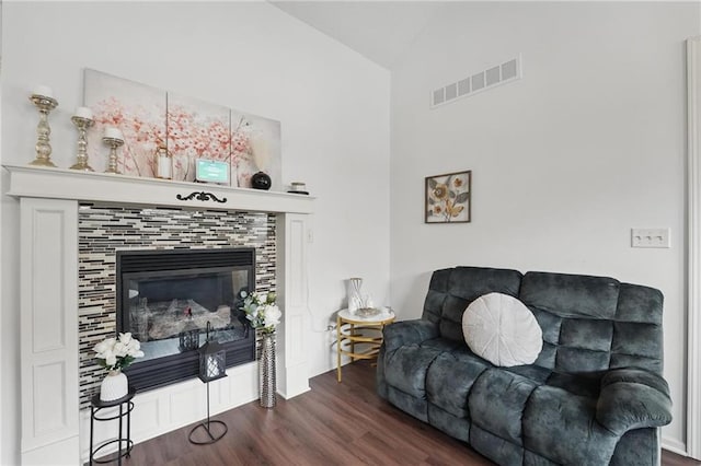 1605 NW Primrose Ln, Blue Springs, MO 64015 - living area with wood finished floors, a tile fireplace, and high vaulted ceiling