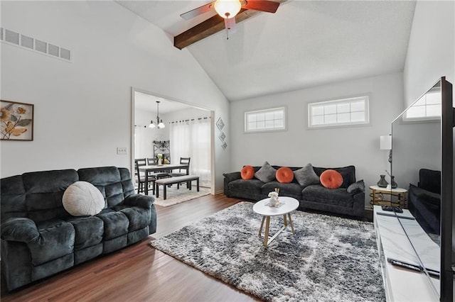 1605 NW Primrose Ln, Blue Springs, MO 64015 - living area featuring beam ceiling, ceiling fan, wood finished floors, a chandelier, and high vaulted ceiling