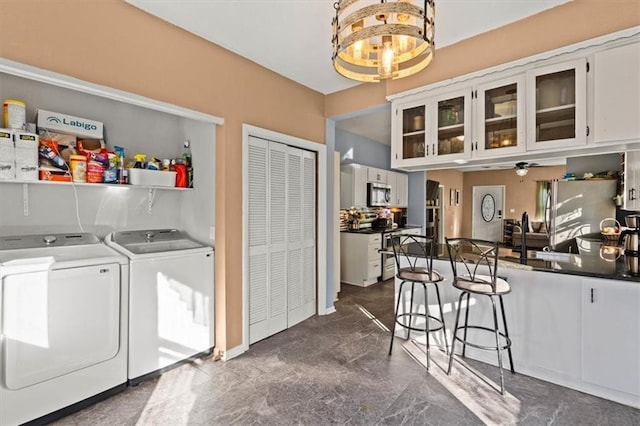 washroom with separate washer and dryer and a ceiling fan