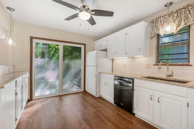 5004 S Kendall Dr, Independence, MO 64055 - kitchen with dishwashing machine, freestanding refrigerator, decorative backsplash, white cabinets, and light stone countertops