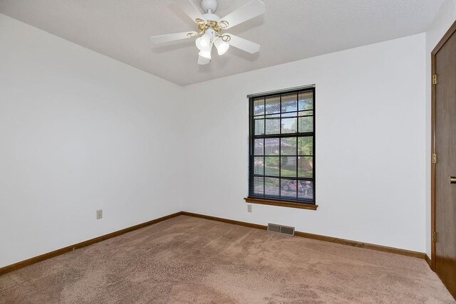 5004 S Kendall Dr, Independence, MO 64055 - empty room with carpet and a ceiling fan