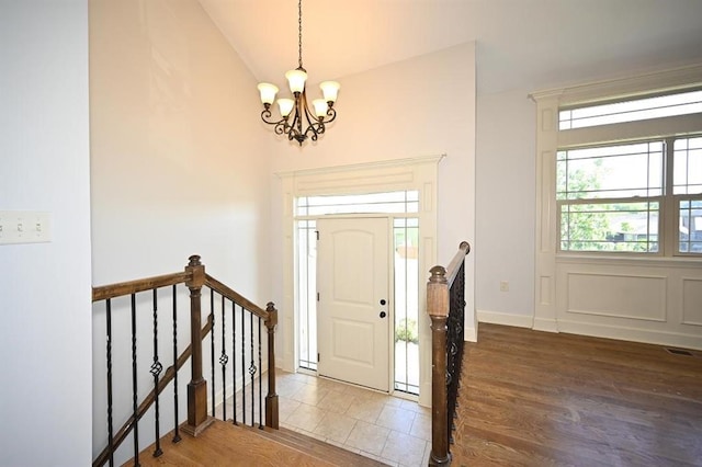 15790 NW 125th St, Platte City, MO 64079 - foyer entrance with a chandelier, wood finished floors, vaulted ceiling, and baseboards