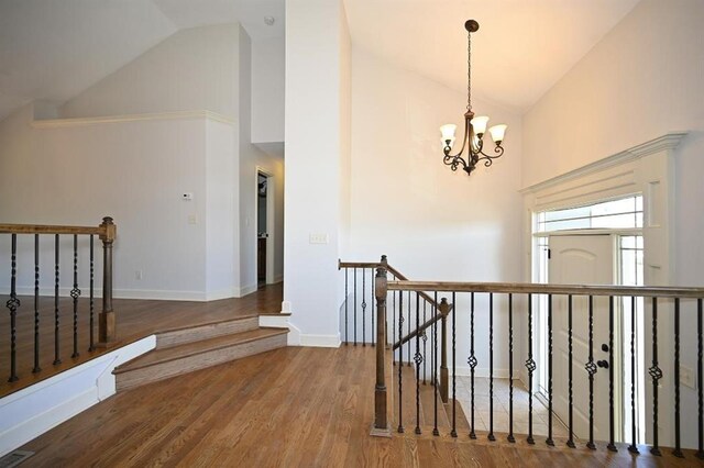15790 NW 125th St, Platte City, MO 64079 - hall with an upstairs landing, high vaulted ceiling, a chandelier, wood finished floors, and baseboards