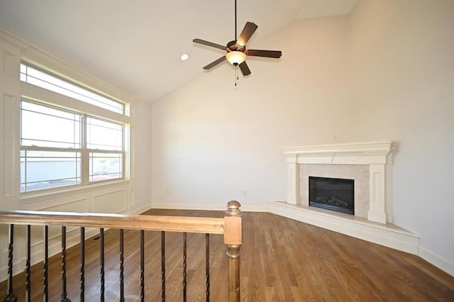 15790 NW 125th St, Platte City, MO 64079 - unfurnished living room with lofted ceiling, a ceiling fan, wood finished floors, baseboards, and a premium fireplace