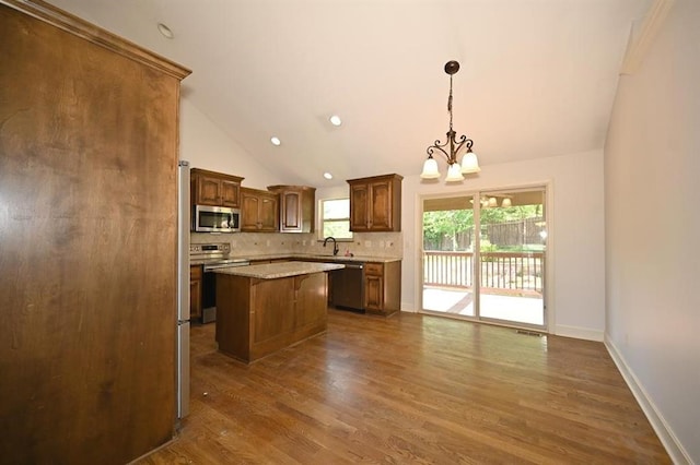 15790 NW 125th St, Platte City, MO 64079 - kitchen with appliances with stainless steel finishes, tasteful backsplash, a chandelier, a center island, and dark wood-type flooring