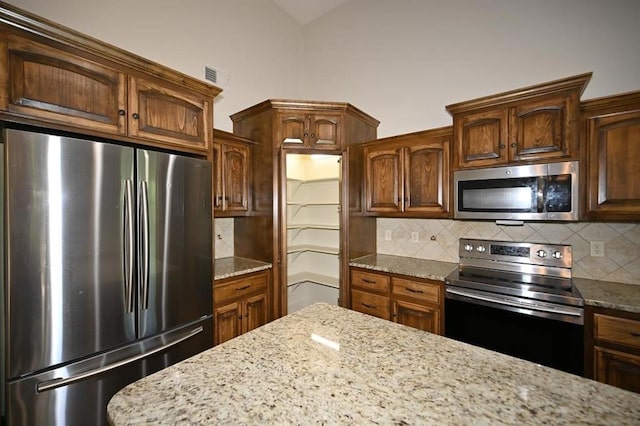 15790 NW 125th St, Platte City, MO 64079 - kitchen with appliances with stainless steel finishes, decorative backsplash, and light stone countertops