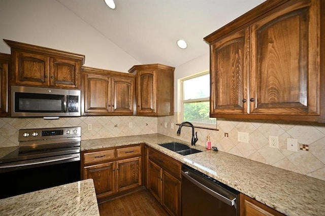 15790 NW 125th St, Platte City, MO 64079 - kitchen featuring stainless steel appliances, a sink, lofted ceiling, light stone counters, and dark wood finished floors