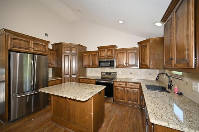 15790 NW 125th St, Platte City, MO 64079 - kitchen featuring stainless steel appliances, a sink, light stone counters, dark wood finished floors, and high vaulted ceiling