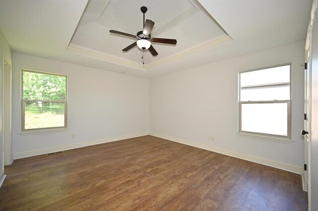 15790 NW 125th St, Platte City, MO 64079 - unfurnished room with a tray ceiling, dark wood-style flooring, a ceiling fan, baseboards, and crown molding