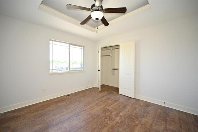 15790 NW 125th St, Platte City, MO 64079 - unfurnished bedroom with a tray ceiling, ornamental molding, baseboards, wood finished floors, and a closet
