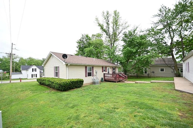705 N Clark St, Edgerton, MO 64444 - back of house featuring a wooden deck and a lawn