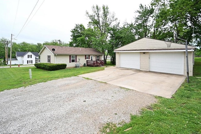 705 N Clark St, Edgerton, MO 64444 - view of front of property with an outdoor structure, a garage, a front lawn, and a wooden deck