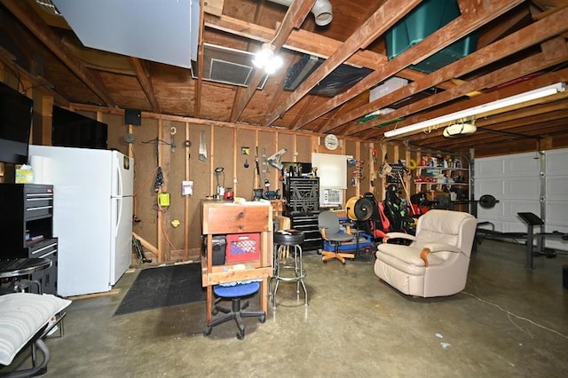 705 N Clark St, Edgerton, MO 64444 - garage featuring freestanding refrigerator and a workshop area