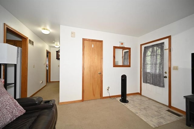 705 N Clark St, Edgerton, MO 64444 - foyer entrance featuring baseboards and light carpet