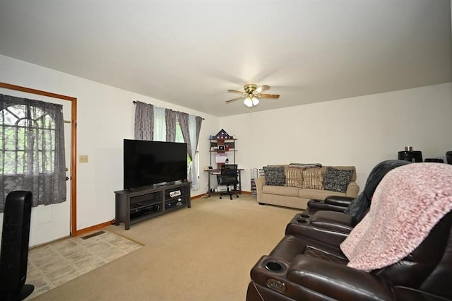 705 N Clark St, Edgerton, MO 64444 - living area featuring healthy amount of natural light, a ceiling fan, light carpet, and baseboards