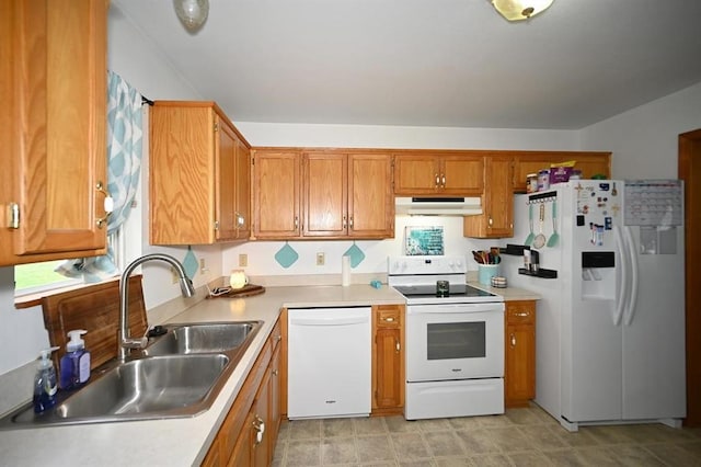 705 N Clark St, Edgerton, MO 64444 - kitchen featuring white appliances, under cabinet range hood, a sink, brown cabinetry, and light countertops