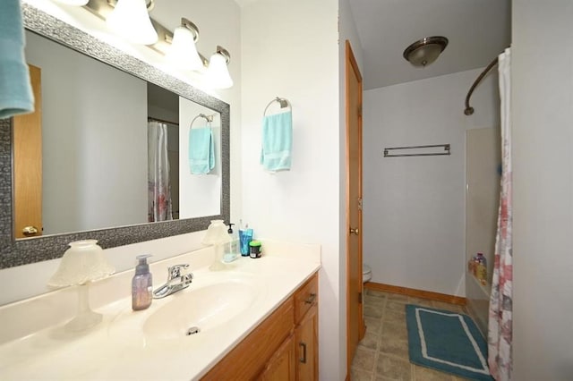 705 N Clark St, Edgerton, MO 64444 - full bathroom with a shower with shower curtain, vanity, toilet, and tile patterned flooring
