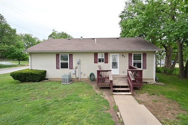 705 N Clark St, Edgerton, MO 64444 - view of front of property featuring central air condition unit, a wooden deck, a front lawn, and roof with shingles