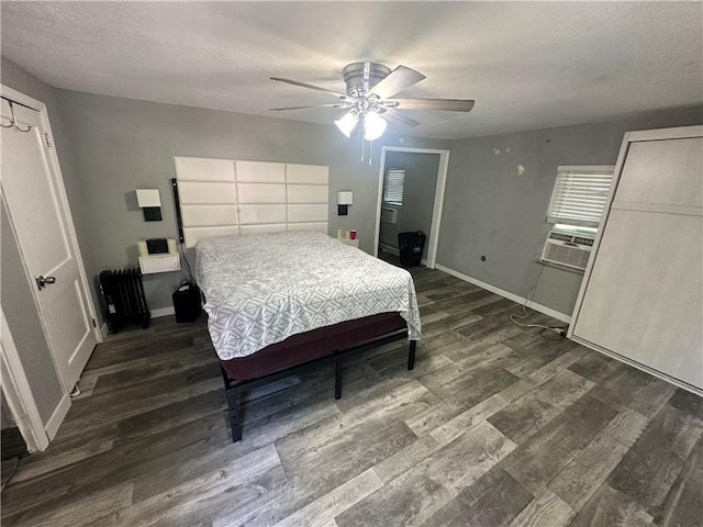 bedroom with wood finished floors and baseboards