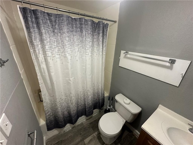full bathroom with shower / tub combo, toilet, and vanity