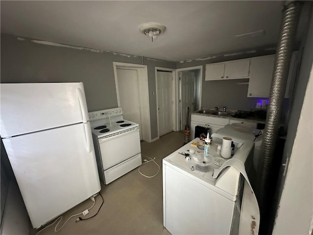 kitchen featuring white appliances, washer / dryer, and white cabinetry