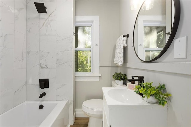 full bathroom with toilet, vanity, baseboards, and shower / bathtub combination