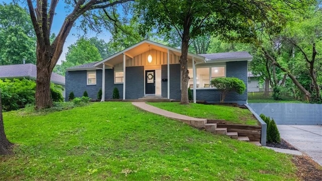 8741 Reeds Rd, Overland Park, KS 66207 - single story home with a front lawn, board and batten siding, brick siding, and a porch