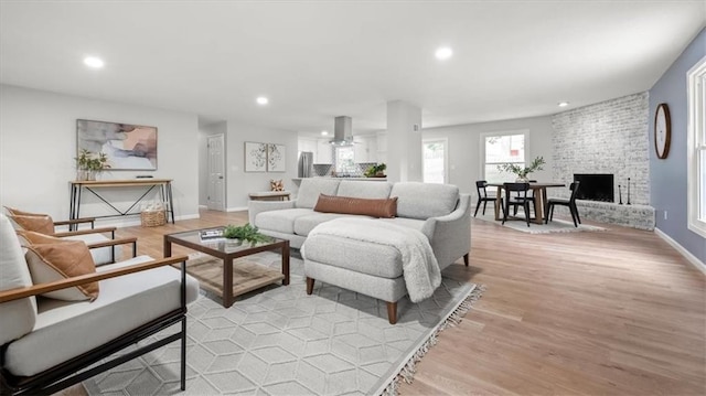 8741 Reeds Rd, Overland Park, KS 66207 - living area featuring light wood-style floors, recessed lighting, baseboards, a fireplace, and a ceiling fan