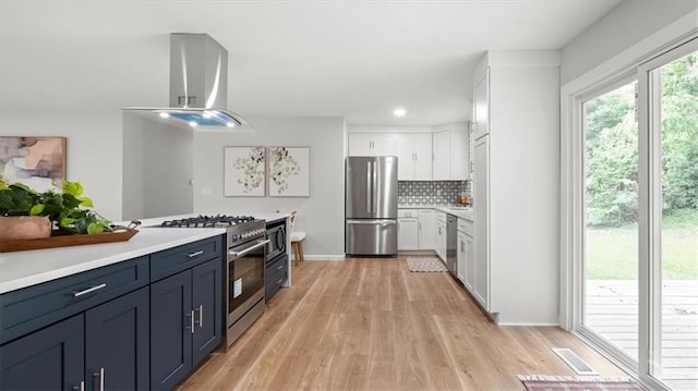 8741 Reeds Rd, Overland Park, KS 66207 - kitchen featuring stainless steel appliances, island exhaust hood, light wood-type flooring, light countertops, and recessed lighting